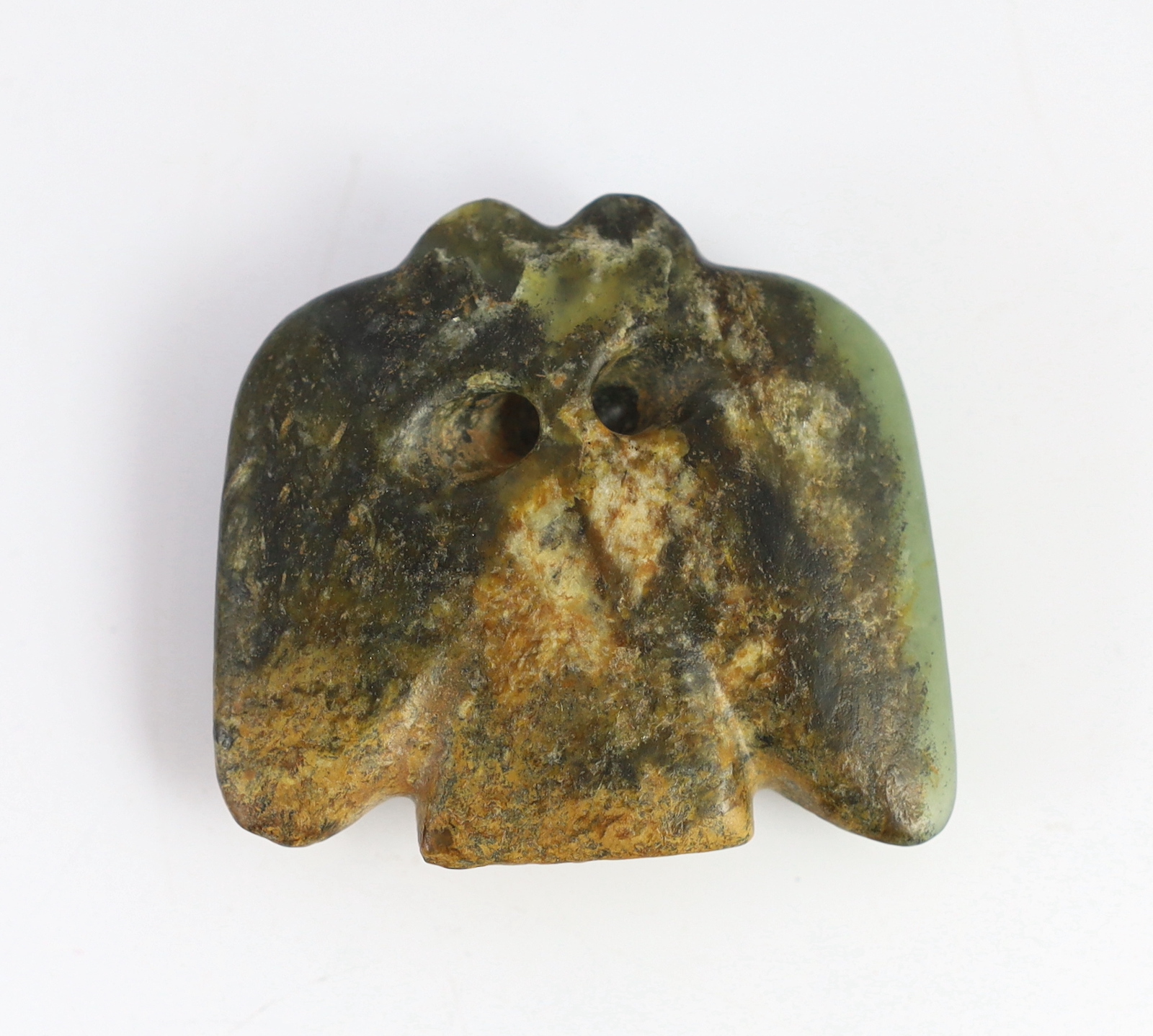 A Chinese archaic green and russet jade carving of a bat or bird, 5.5 cm wide